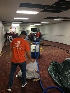 Technicians Repairing Leak Damage In An Office Space